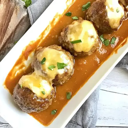 Cheese Stuffed Meatballs with a Creamy Tomato Sauce